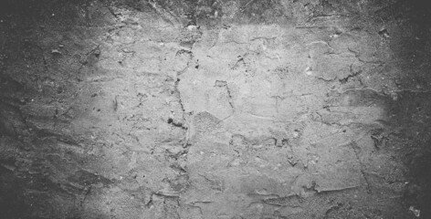 Black concrete wall or dark gray rough grainy stone texture background.