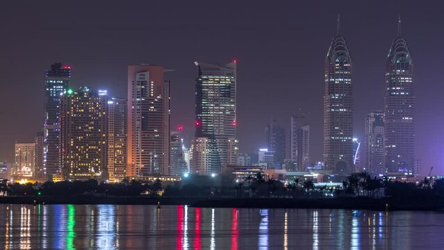 Skyscrapers at the Dubai Internet City illuminated at night timelapse. United Arab Emirates, Middle East