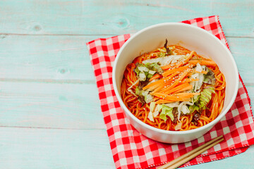 Jjolmyeon refers to thick flour noodles characterized by their chewiness. It is usually topped with cucumber, cabbage, and bean sprout and mixed with a gochujang (red chili paste) sauce at the table.