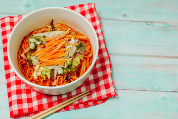 Jjolmyeon refers to thick flour noodles characterized by their chewiness. It is usually topped with cucumber, cabbage, and bean sprout and mixed with a gochujang (red chili paste) sauce at the table.