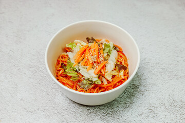 Jjolmyeon refers to thick flour noodles characterized by their chewiness. It is usually topped with cucumber, cabbage, and bean sprout and mixed with a gochujang (red chili paste) sauce at the table.