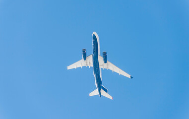 A big plane in the blue sky is flying