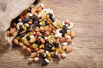 mixed nuts with dried fruits on wooden background