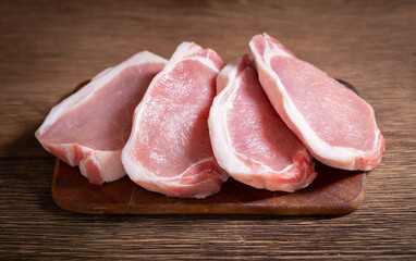 Pork chops on wooden board