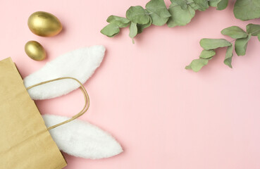 Easter background with rabbit ears and golden eggs. Easter concept.