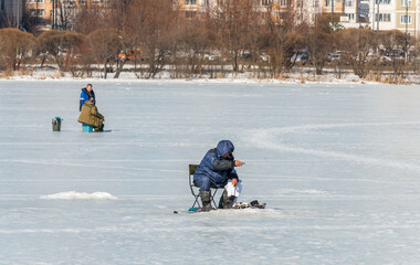 A fisherman catches fish on the city pond March 19 , 2022 in Moscow