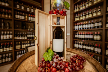 A Wine Bottle On Wood Table With Red Grapes In A Bar