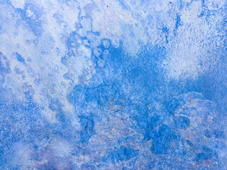 A rusty blue metal wall with spots and scuffs. Vintage background with texture. Rough surface.