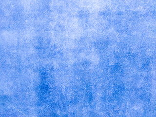 A rusty blue metal wall with scratches and scuffs. Vintage background with texture. Rough surface.
