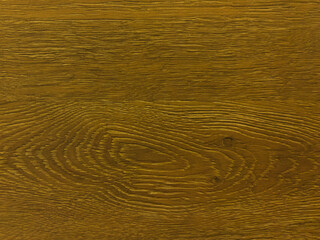 An old brown wooden wall with annual tree rings. Vintage brown background with wooden texture.