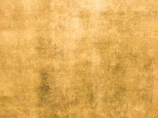 Rusty yellow metal wall with scratches and scuffs. Vintage background with texture. Rough surface.
