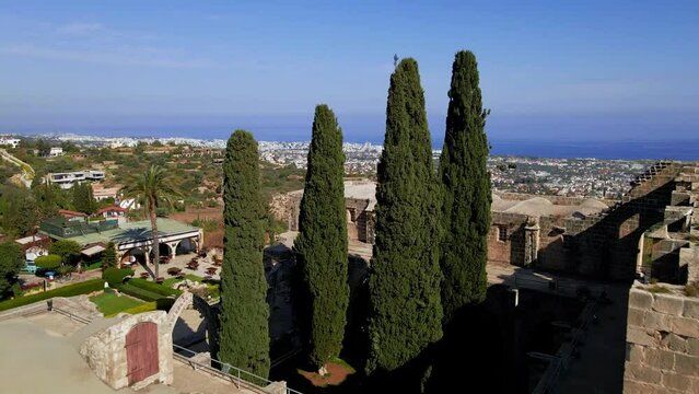 Aerial 4K view of beautiful Bellapais Village with Bellapais Monastery in Kyrenia, North Cyprus surrounded with an amazing green Mediterranean nature and picturesque landscapes in Cyprus.