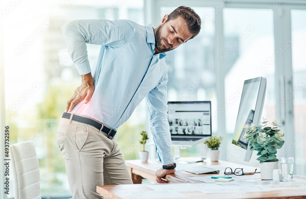 Poster i need to work on my posture to prevent this pain. shot of a young businessman suffering with back p