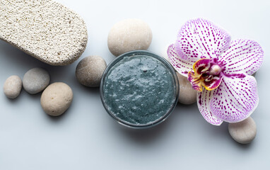 natural body or face scrub. olive and clay body polish, sea ebbles, orchid flower. flat layx top biew. spa, wellness and relax concept . skin care. advertising template 