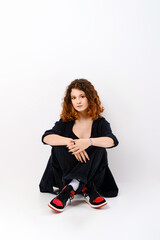 Fototapeta premium Cute girl sitting in studio on the floor