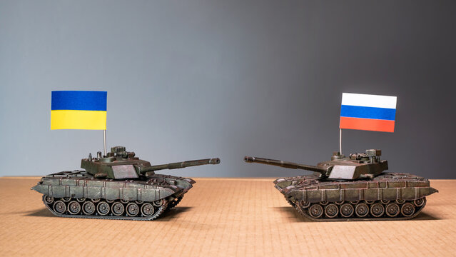 Toy tanks with Ukrainian and Russian flags