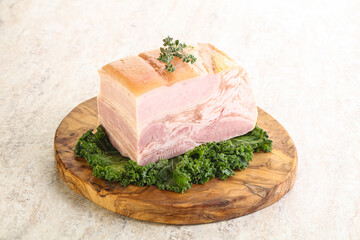 Cut of pork bacon over board