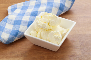 Italian soft mascarpone cheese in the bowl