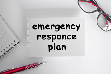 EMERGENCY RESPONCE PLAN. The notebook is on paper with text . eyeglasses. Concept photo.