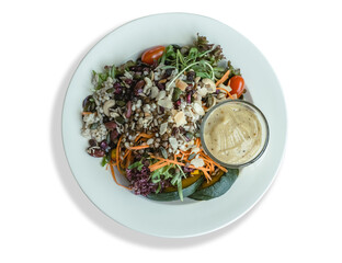 Top view Mixed Grain Salad with vegetables and salad dressing on plate on white background , clipping path, studio shot