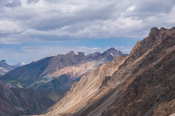 Beautiful mountain range with cloudy sky background. Hiking, trekking concept. Landscape background. Barskoon mountain pass.