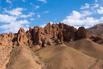 Beautiful red clay mountains eroded on wind. Red mountains or red canyon on the way from Assy plateau to Bartogai reservoir. Mountain canyon landscape.