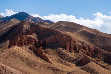 Beautiful red clay mountains eroded on wind. Red mountains or red canyon on the way from Assy plateau to Bartogai reservoir. Mountain canyon landscape.