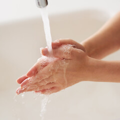 Fototapeta premium Rinse while rubbing. Cropped shot of hands being washed at a tap.