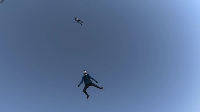 skydiving, free fall, a man in the clouds, parachutists jump out of an airplane