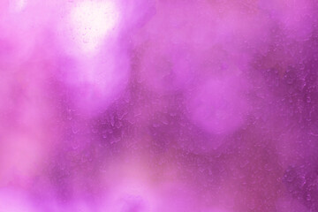 The surface of a window pane stained and streaked by dried raindrops. Blurred texture with smooth transitions.