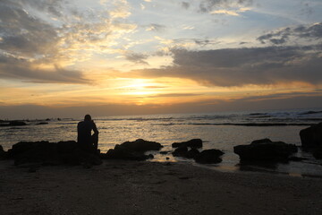 Man alone in the sea lonely feeling sunset time. High quality photo