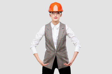 Young caucasian engineer businesswoman wearing orange constraction helmet and googles holds product...