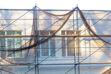 A building under repair with a scaffolding - concept of finishing works