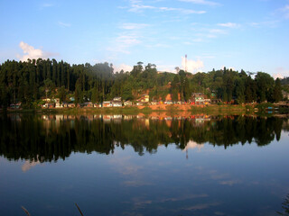 The conifer pine trees and houses mirrored at Sumendu Lake look mesmerizing at Mirik in Darjeeling. This is an old artificial lake measuring around 1.25 km long and main attraction of the place.