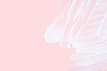 Texture of moisturizer on pink background. Natural organic spa cosmetics concept. Top view, copy space.