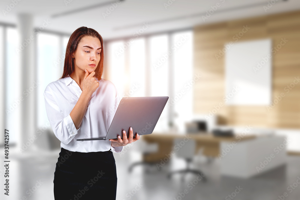 Poster young attractive businesswoman wearing formal suit is holding la