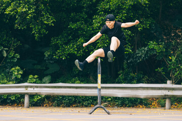 Female runner jumping over a hurdle