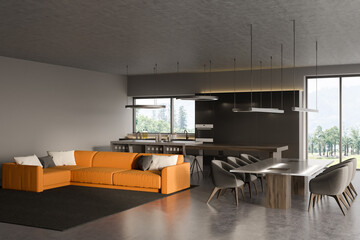 Dark studio interior with kitchen, sofa, panoramic window, dining table