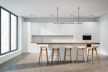 Front view on bright kitchen interior with island with barstools
