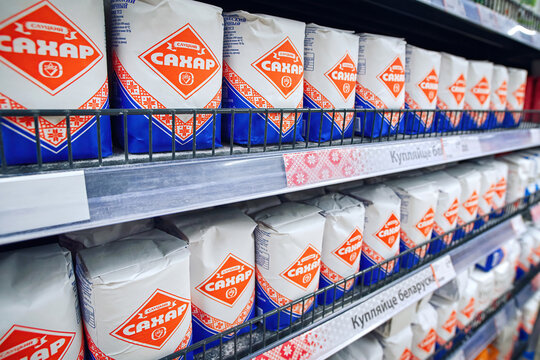 Minsk, Belarus. Mar 2022. Sugar on the shelf of supermarket in Belarus. Slutsk Sugar Refinery, packed sugar in paper bags in grocery store. Inscription - Sugar
