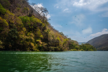 Sumidero Canyon is a deep natural canyon located on Grijalva River in Chiapas State in Southern Mexico. The Canyon's vertical walls can reach up to 1,000 meters high and it is covered with rainforest.