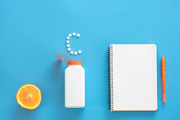 Flat lay, pills on blue background, vitamin c concept.
