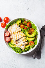 Grilled chicken breast salad with avocado and cherry tomatoes. Healthy diet food concept.