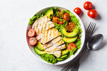 Grilled chicken breast salad with avocado and cherry tomatoes. Healthy diet food concept.