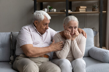 Loving old husband comforting sad senior wife, apologizes to his spouse after quarrel, goes to...