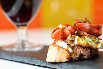 Plated bruschetta with a side of wine