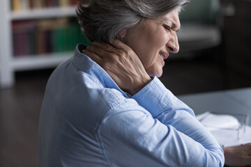Close up unhealthy old 60s woman suffer from neckache, pinched nerves, massaging stiff sore neck or tensed muscles relieving painful feelings. Incorrect posture, fibromyalgia, chronic diseases concept - obrazy, fototapety, plakaty