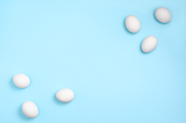 White eggs on pastel blue background 