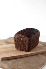 a loaf of wholegrain bread on cutting board