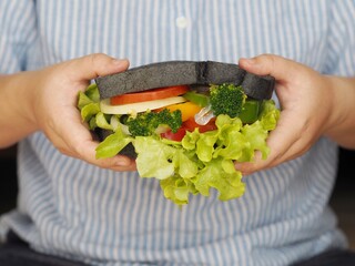 Plant base vegetarian food on woman hand    